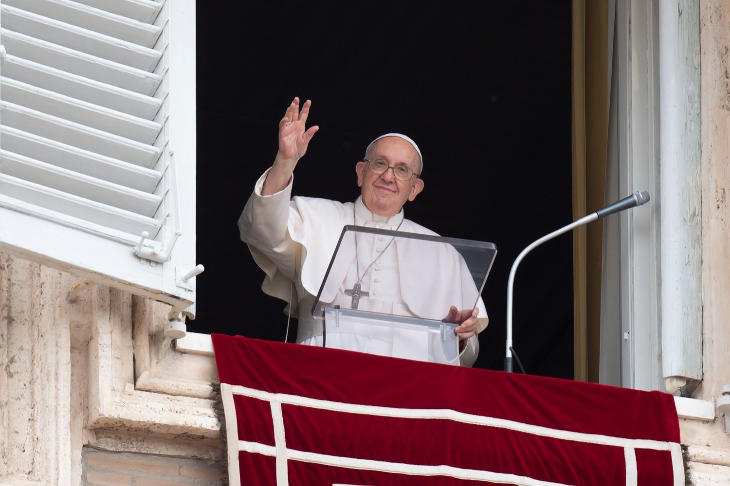 Pope Francis greets the crowd as he leads the “Regina Coeli” prayer from the window of his studio overlooking St. Peter’s Square at the Vatican May 8.